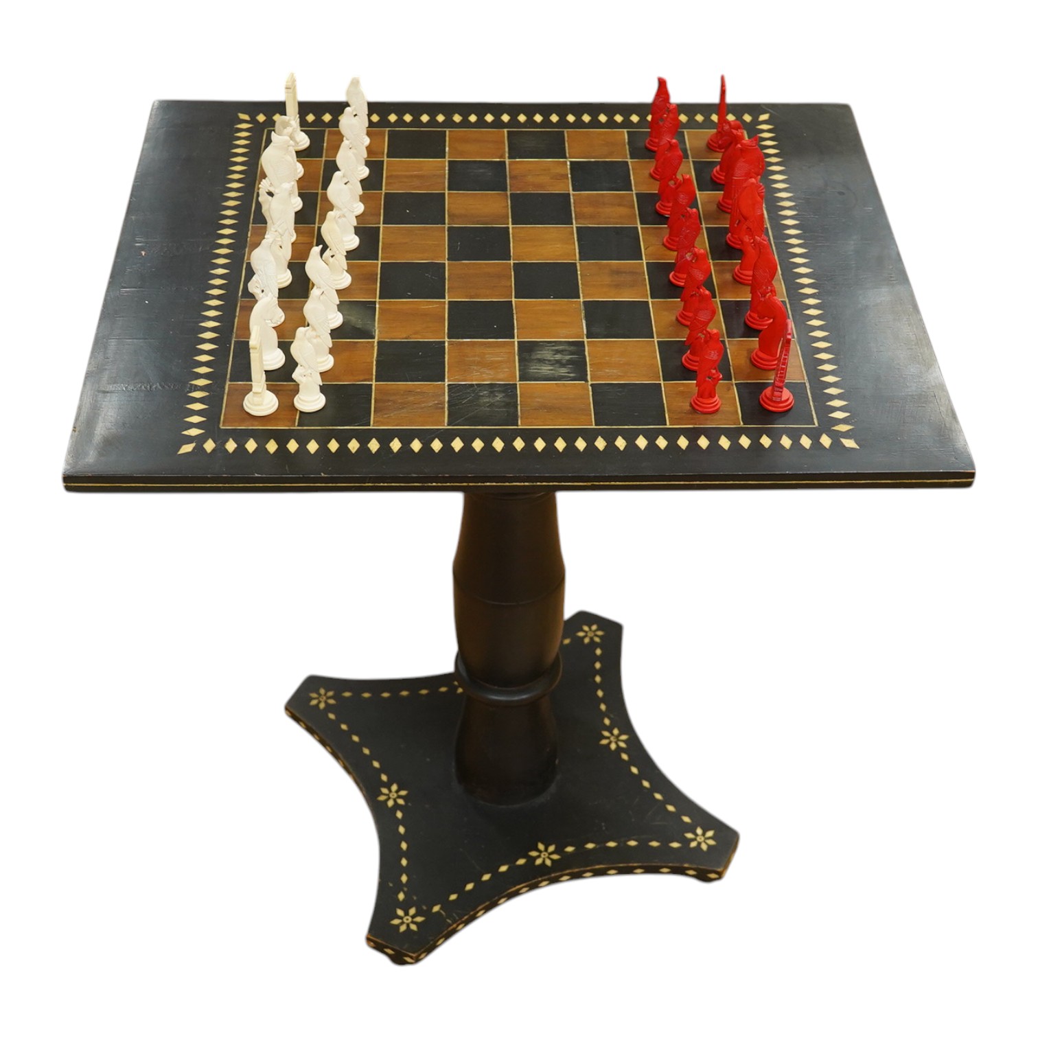 A Sri Lankan chess table and a boxed bone chess set, table measures 62cm high. Condition - good